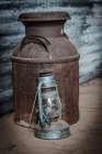 Still-life on a ranch. Milk can and lantern. Art Print